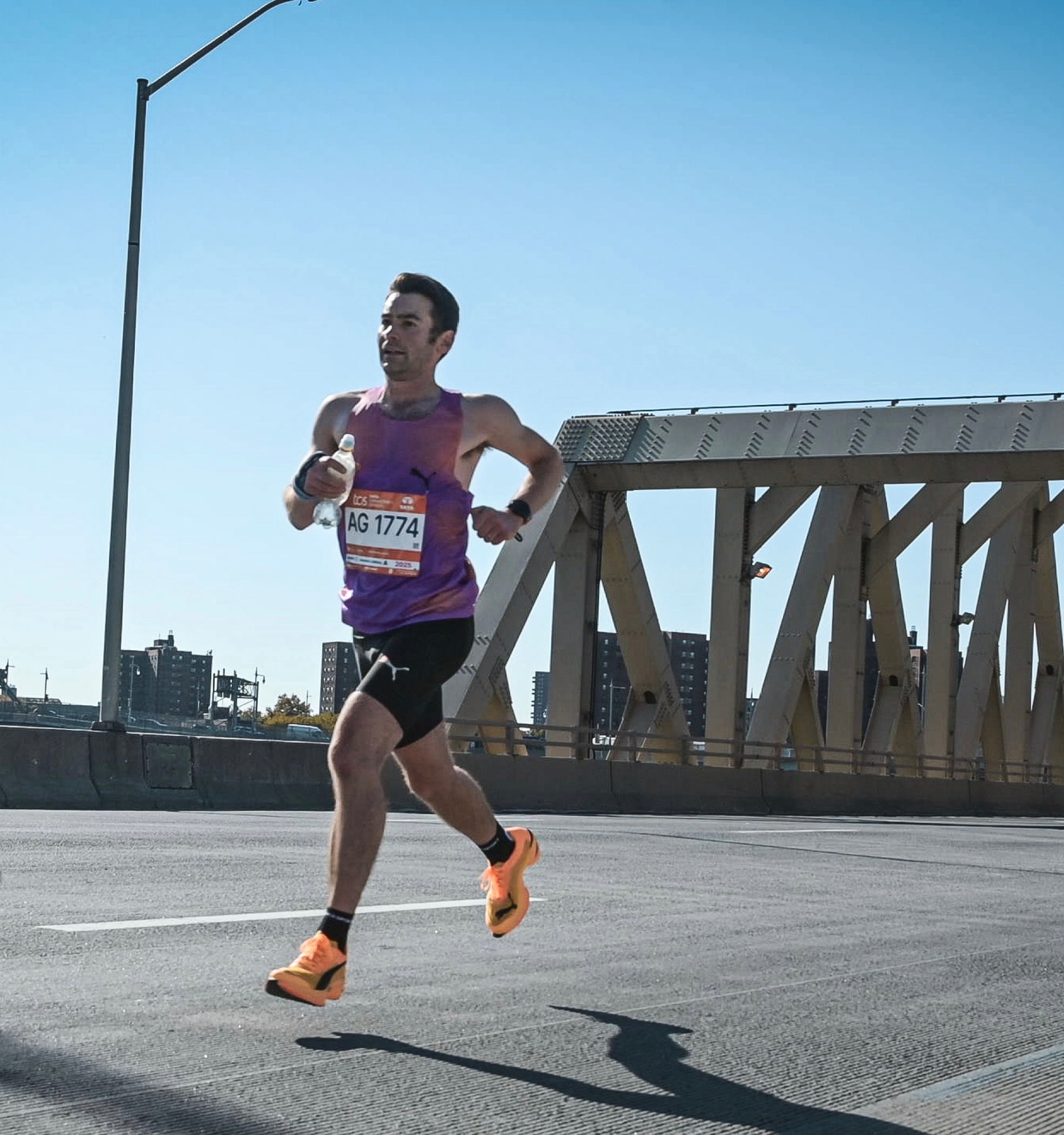 Nick racing on a New York bridge in the Puma Project3 vest