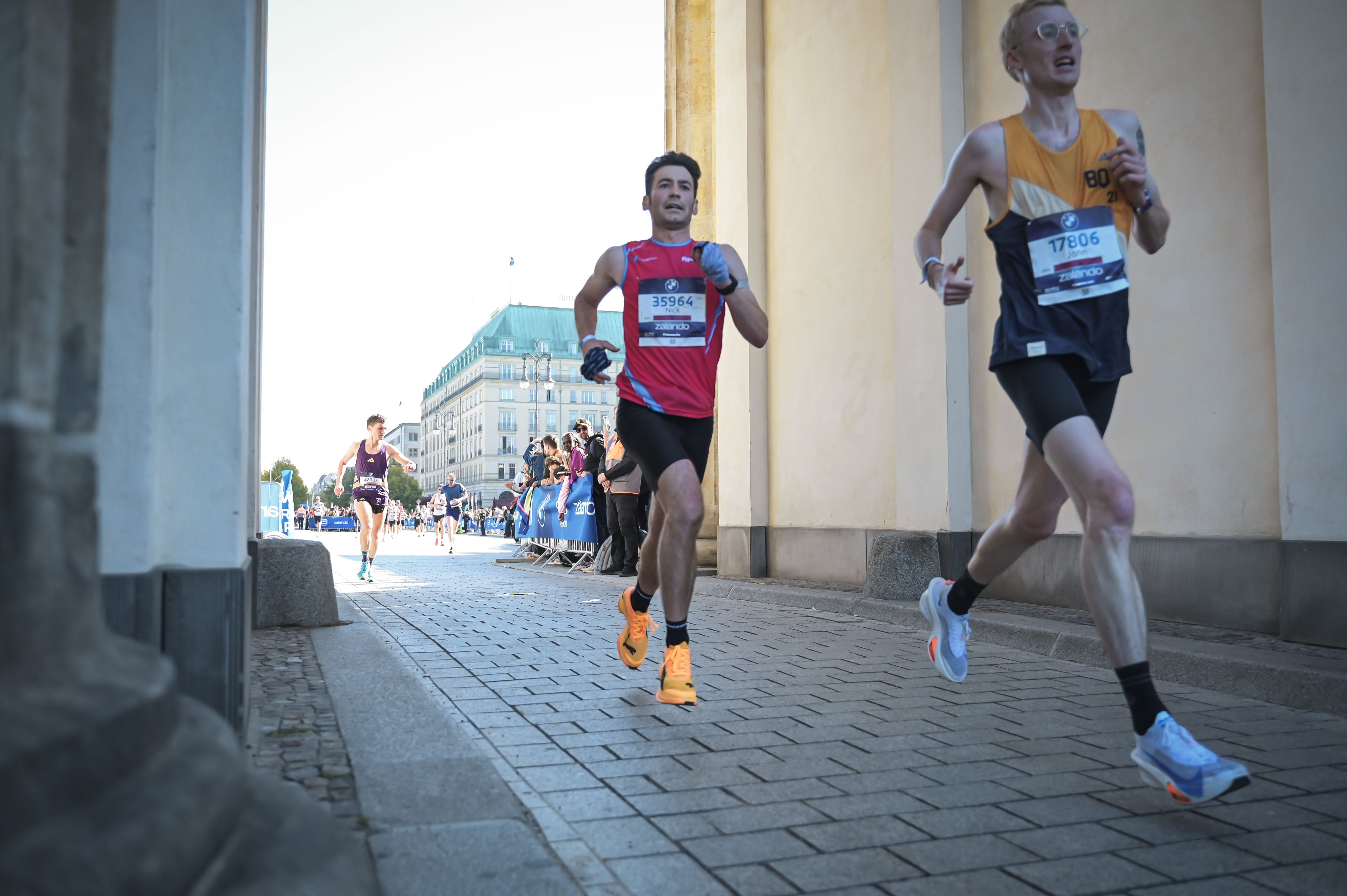 Nick Weston running under the Brandenburg Gate at the finish of Berlin Marathon 2026